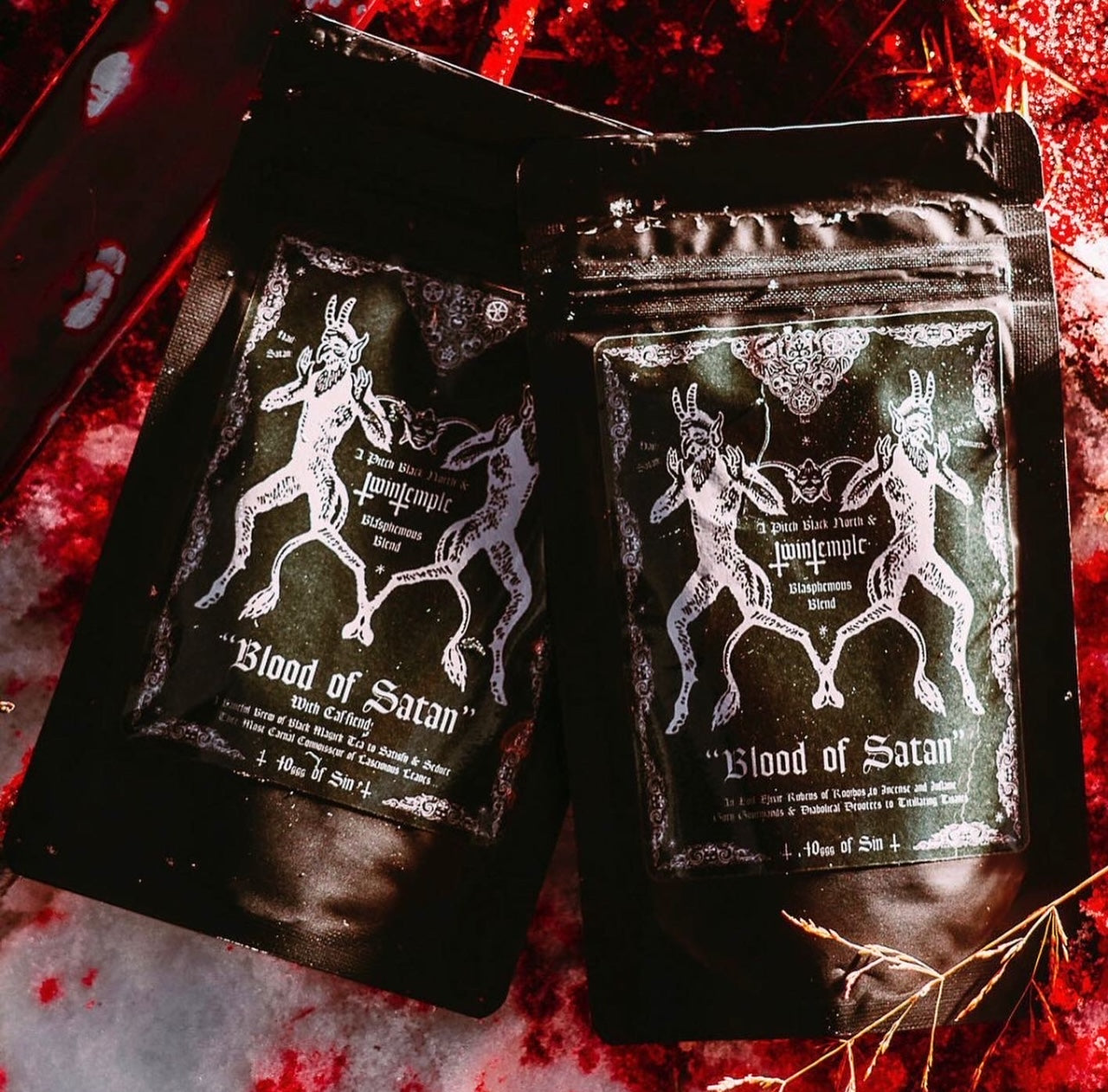A black resealable pouch of Twin Temple "Blood of Satan" tea, featuring an illustration of two horned, demonic figures.
